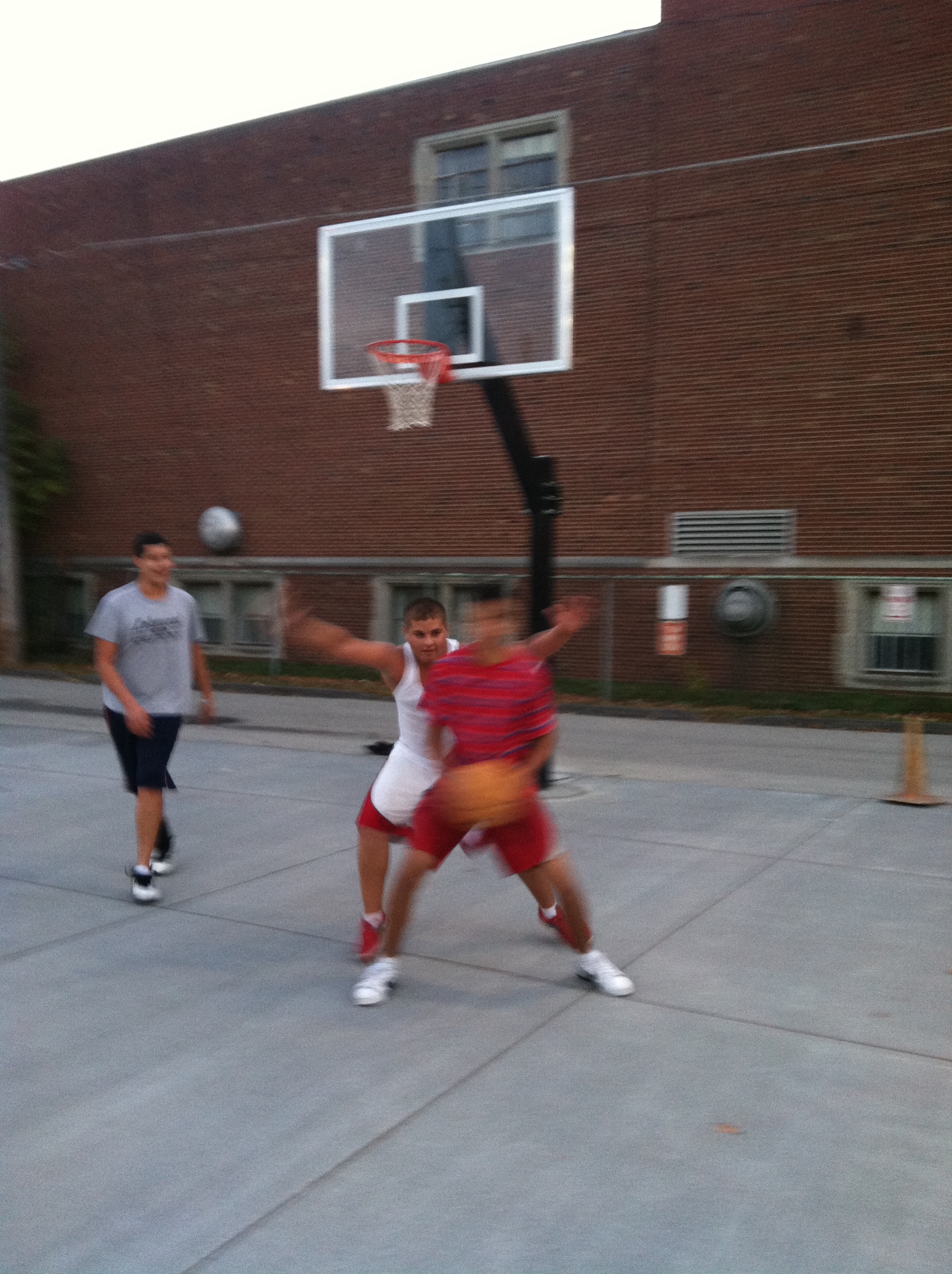Here Kevin tries to make a move on Yacub(Manny's most improved player btw)while Mo, smiling in the background, has grown from about 5'8" to over 6'2" and who is very proud of how much stronger he as gotten spending a couple hours everyday at the Kauffman courts since the opened two years ago.