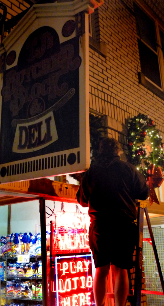 Putting up holiday decorations at TJ's Butcher Block.