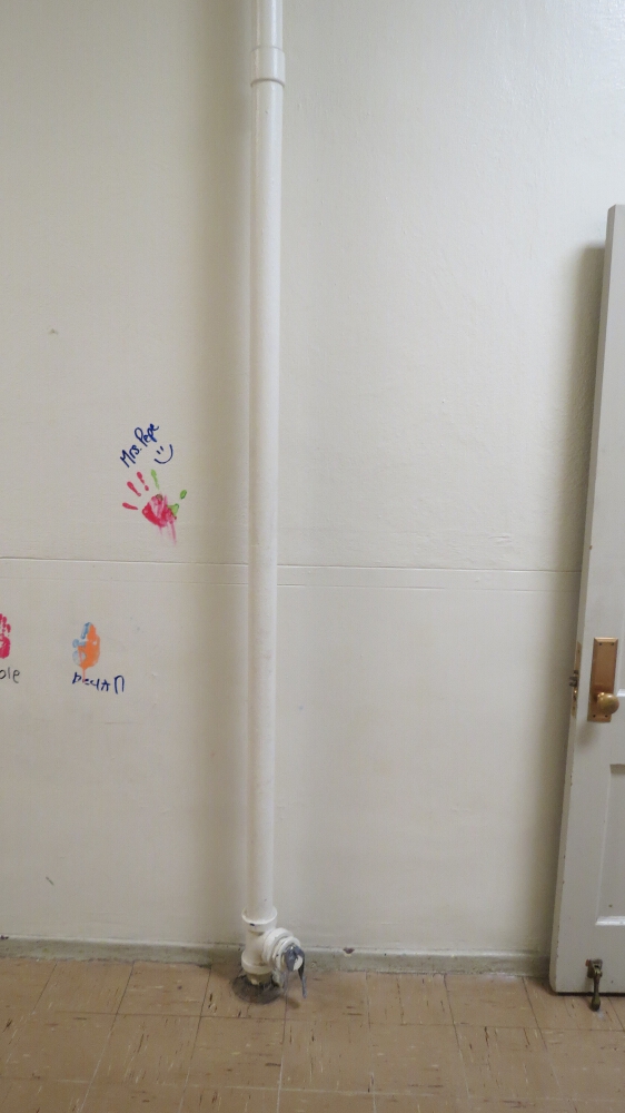 This pipe was part of the vacuum system, this was where all the erasers were collected and cleaned by banging them on a wooden stool that was connected to the vac sys with a hose.